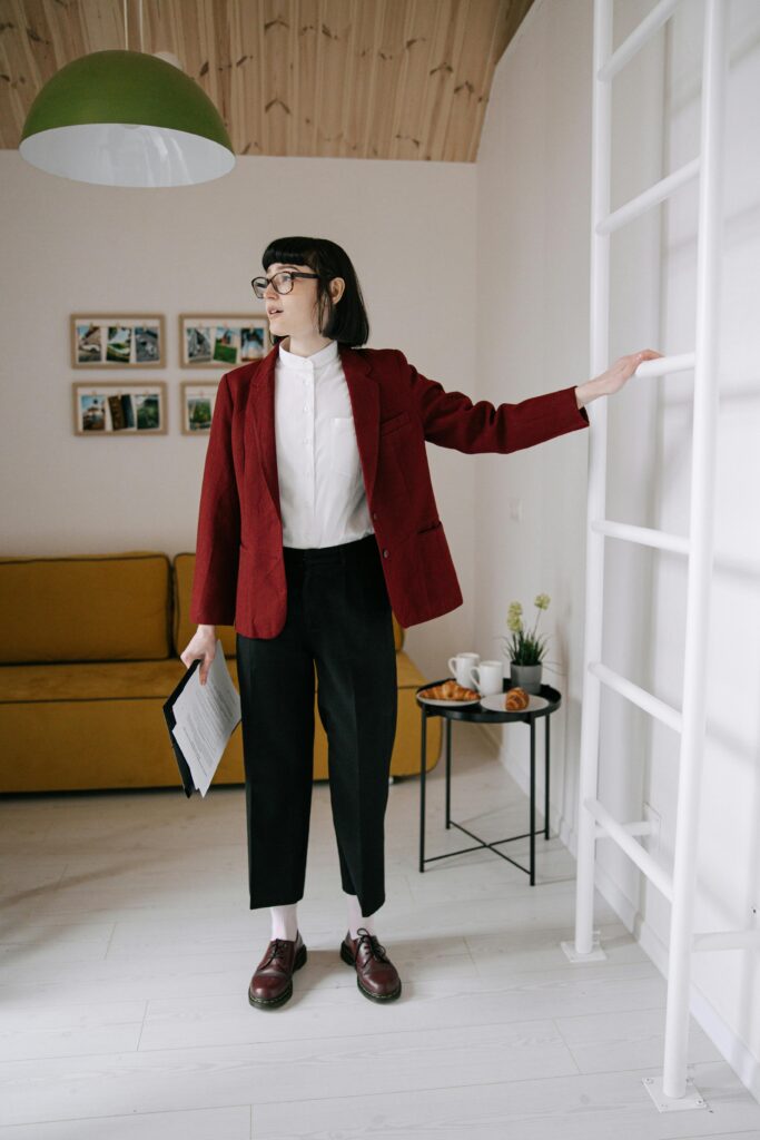 pexels-photo-8962572-8962572 Young woman in a modern apartment with chic decor, holding a real estate document.